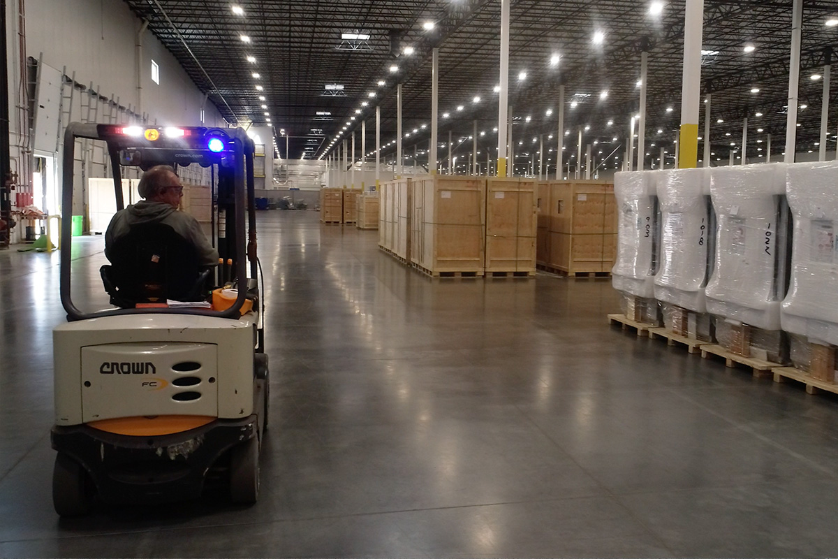 Photo of warehouse worker checking and moving inventory